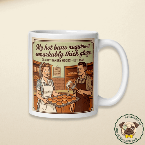 Vintage 1940s style illustration on a ceramic mug of a smiling female baker holding a tray of round buns next to a male baker holding a large brush dripping with white icing. The bold text above them reads My hot buns require a remarkably thick glaze. Quality Bakery Goods Est. 1942.