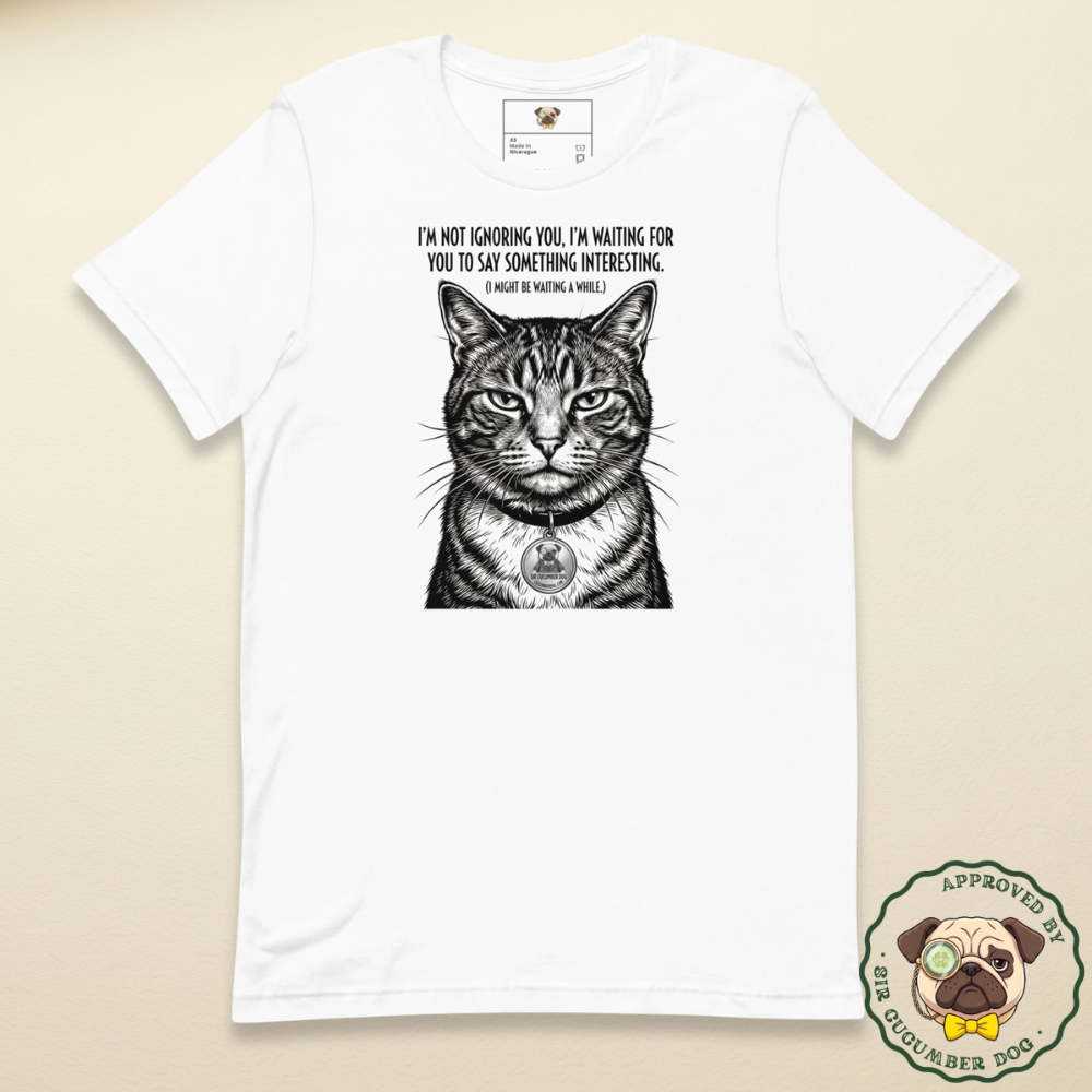 Vintage style black and white engraved illustration of a judgemental tabby cat on a white t-shirt. The text reads I'm not ignoring you, I'm waiting for you to say something interesting. (I might be waiting a while)