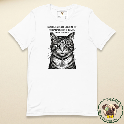 Vintage style black and white engraved illustration of a judgemental tabby cat on a white t-shirt. The text reads I'm not ignoring you, I'm waiting for you to say something interesting. (I might be waiting a while)