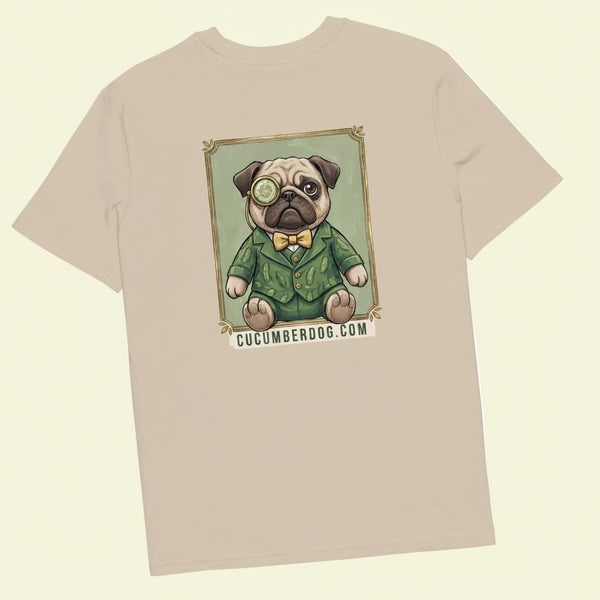 The back of a light sand coloured t-shirt. It features a vintage style framed illustration of Sir Cucumber Dog, a pug wearing a green cucumber print suit, yellow bow tie, and a monocle. The text below the portrait reads CUCUMBERDOG.COM.