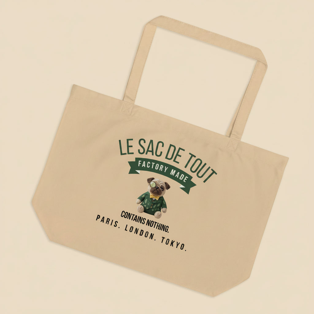 A premium oyster coloured organic cotton tote bag featuring a satirical luxury fashion design. The top text reads LE SAC DE TOUT in a curved Cucumber green font above a matching green banner with the words FACTORY MADE. In the center is an illustration of Sir Cucumber Dog, a plush pug wearing a dapper green cucumber print suit, yellow bow tie, and monocle. Below the icon, black typography reads CONTAINS NOTHING. and PARIS. LONDON. TOKYO.