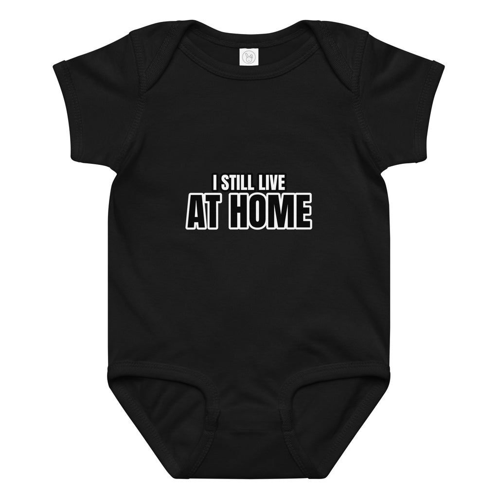 Black baby onesie with 'I STILL LIVE AT HOME' text on a white background. CUcumber Dog