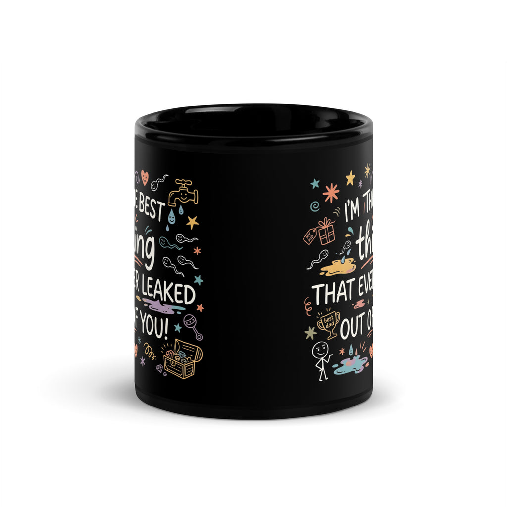 A tilted black glossy ceramic mug on a light beige background. The design features colourful hand drawn typography and doodles. The text reads I'M THE BEST thing THAT EVER LEAKED OUT OF YOU! in white and teal script. The surrounding icons include white sperm cells, a dripping golden tap, hearts, stars, a treasure chest, and a baby rattle in pastel colours.