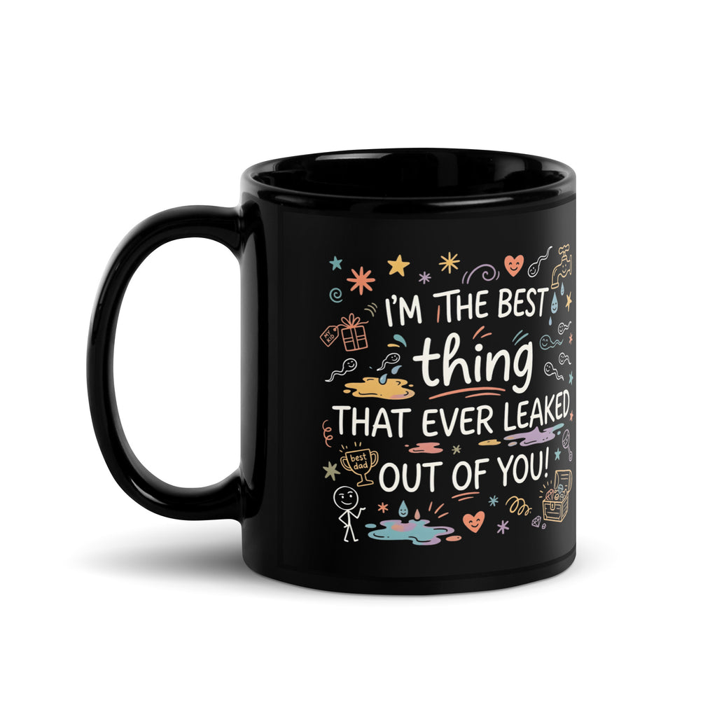 A tilted black glossy ceramic mug on a light beige background. The design features colourful hand drawn typography and doodles. The text reads I'M THE BEST thing THAT EVER LEAKED OUT OF YOU! in white and teal script. The surrounding icons include white sperm cells, a dripping golden tap, hearts, stars, a treasure chest, and a baby rattle in pastel colours.