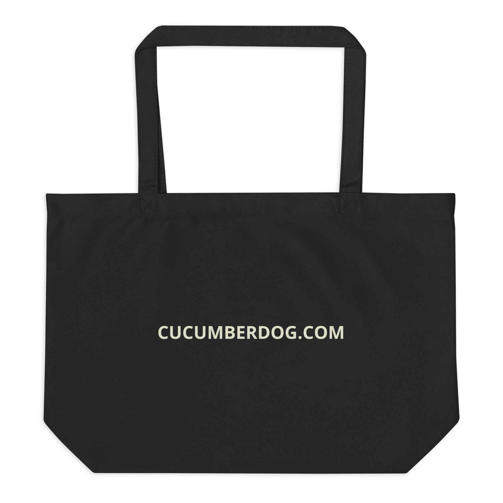 A heavy-duty black organic cotton tote bag featuring a high-definition illustration of Sir Cucumber Dog on the front with the text SIR CUCUMBER DOG. The back features the website CUCUMBERDOG.COM in cream text.