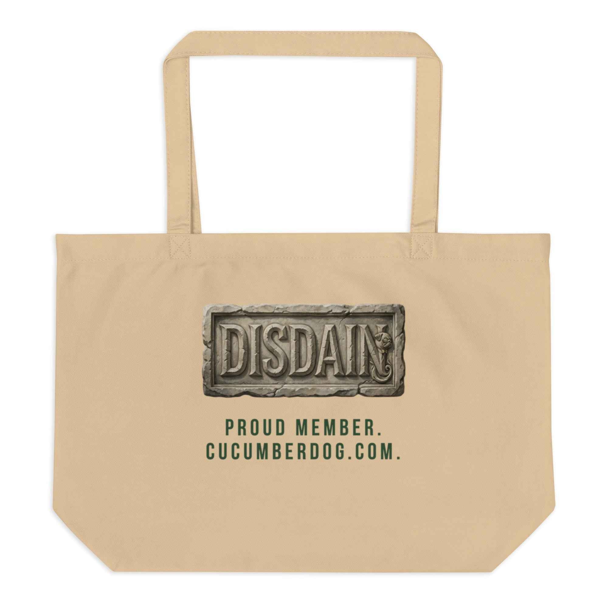 A heavy duty oyster organic cotton tote bag featuring a black rectangular print. Inside the black area is a realistic 3D stone carving of the word DISDAIN with Sir Cucumber Dog's profile hidden in the letter N. Green text below reads PROUD MEMBER CUCUMBERDOG.COM.