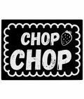 Black and white textured glass chopping board with scalloped border and the slogan "CHOP CHOP" next to a strawberry illustration.
