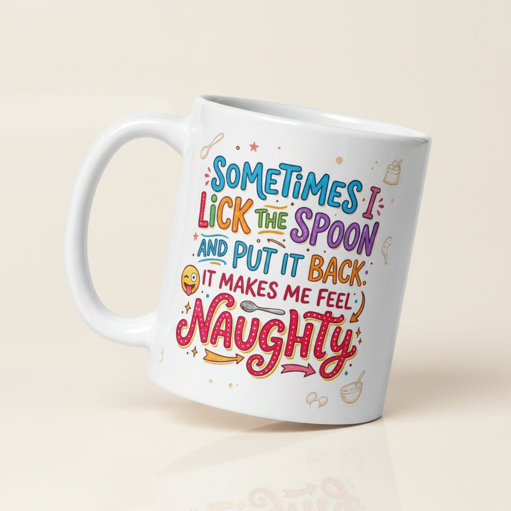 A white ceramic mug featuring playful and colourful typography in blue, pink, orange, and purple. The text reads SOMETIMES I LICK THE SPOON AND PUT IT BACK IT MAKES ME FEEL NAUGHTY. The design is decorated with small hand drawn icons of spoons, stars, a bag of flour, and a winking emoji with its tongue sticking out.