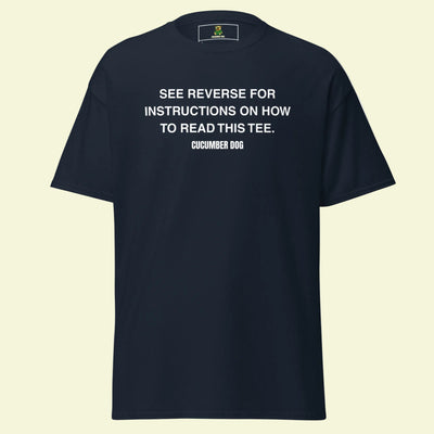 Navy t-shirt with the words see reverse for instructions on how to read this tee. White text on a white background. Cucumber Dog