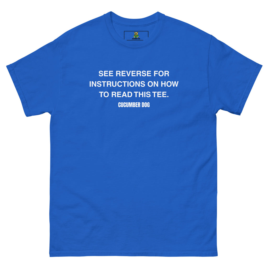 Blue t-shirt with the words see reverse for instructions on how to read this tee. White text on a white background. Cucumber Dog