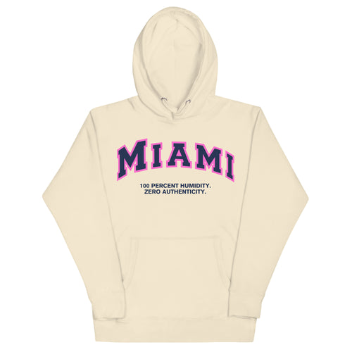 Premium bone coloured hoodie featuring a vintage athletic graphic with arched Miami text in dark blue and pink, and the phrase 100 Percent Humidity Zero Authenticity printed underneath in a solid black serif font.