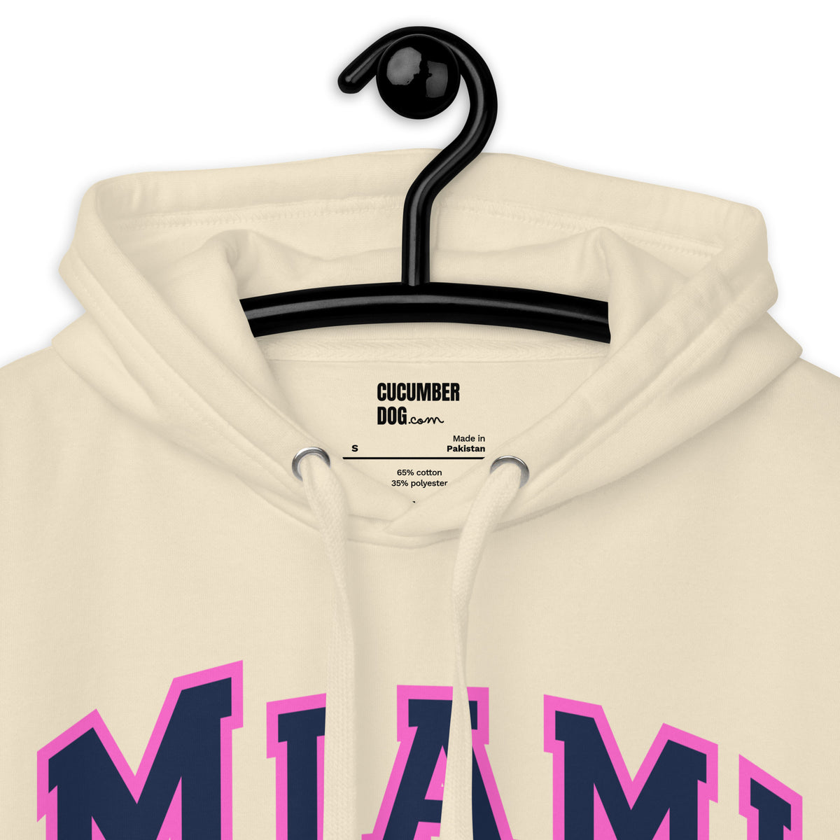 Premium bone coloured hoodie featuring a vintage athletic graphic with arched Miami text in dark blue and pink, and the phrase 100 Percent Humidity Zero Authenticity printed underneath in a solid black serif font.