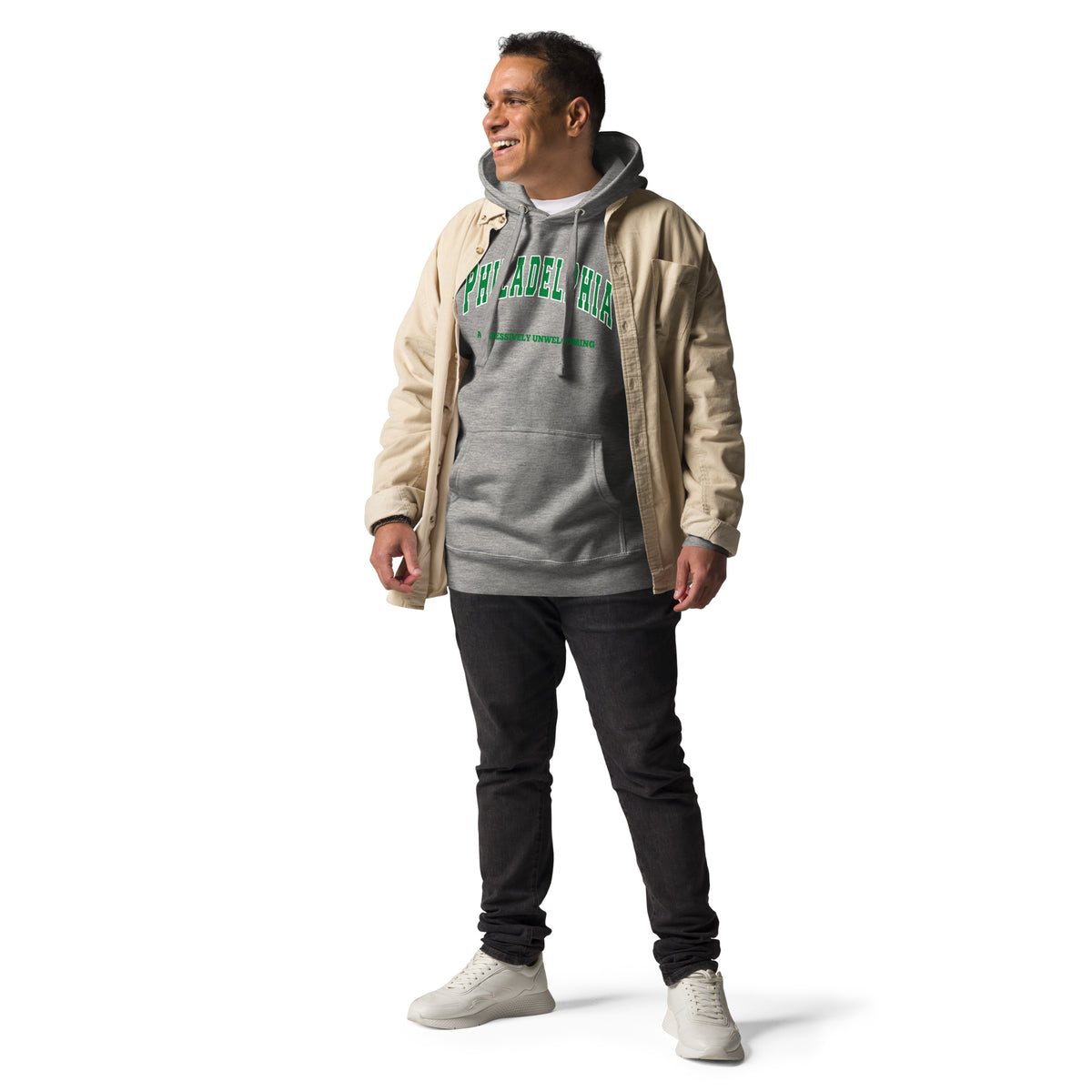 Premium carbon grey hoodie featuring a vintage athletic graphic with arched Philadelphia text in green and white, and the phrase Aggressively Unwelcoming printed underneath in a solid green serif font.
