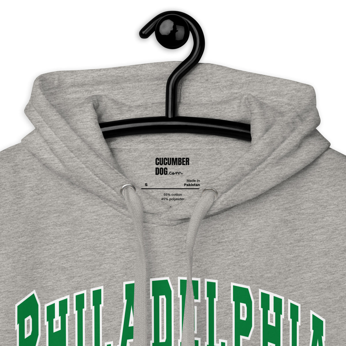 Premium carbon grey hoodie featuring a vintage athletic graphic with arched Philadelphia text in green and white, and the phrase Aggressively Unwelcoming printed underneath in a solid green serif font.