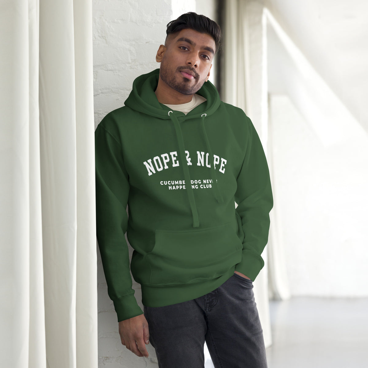 Forest green hoodie featuring the text Nope & Nope in arched white collegiate typography above Cucumber Dog Never Happening Club in white text applied via DTF printing.