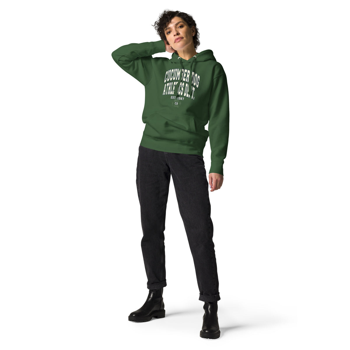 Premium forest green hoodie featuring a vintage athletic graphic with arched Cucumber Dog and Athletics Dept text in solid cream with a navy outline block typography, above Est. 1987 and a track motif framing the CD monogram.