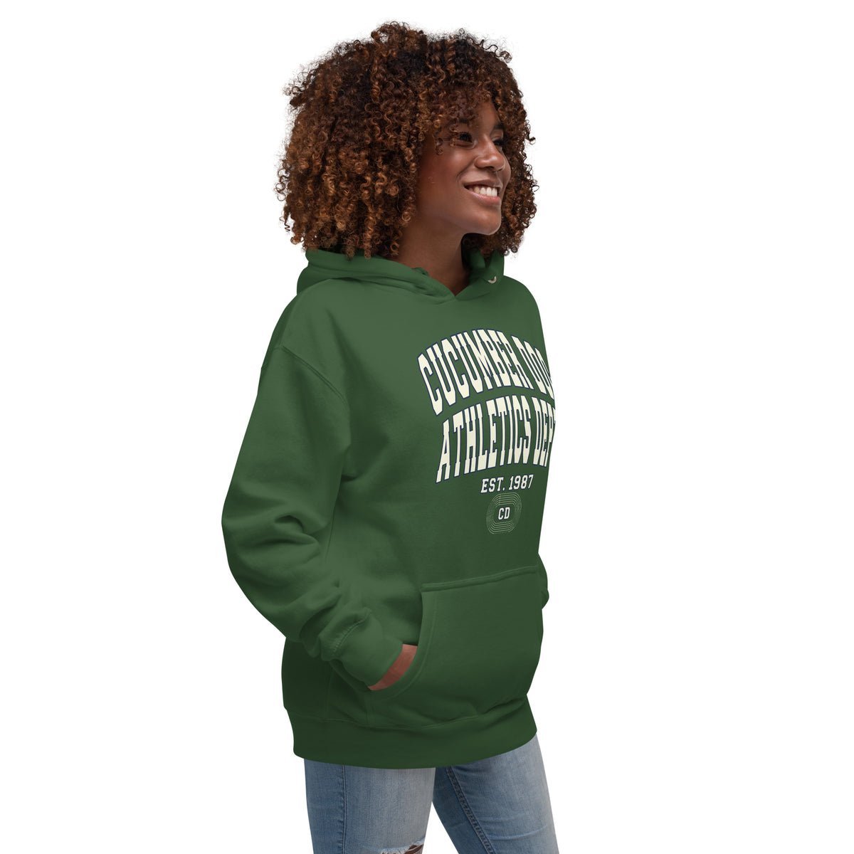 Premium forest green hoodie featuring a vintage athletic graphic with arched Cucumber Dog and Athletics Dept text in solid cream with a navy outline block typography, above Est. 1987 and a track motif framing the CD monogram.