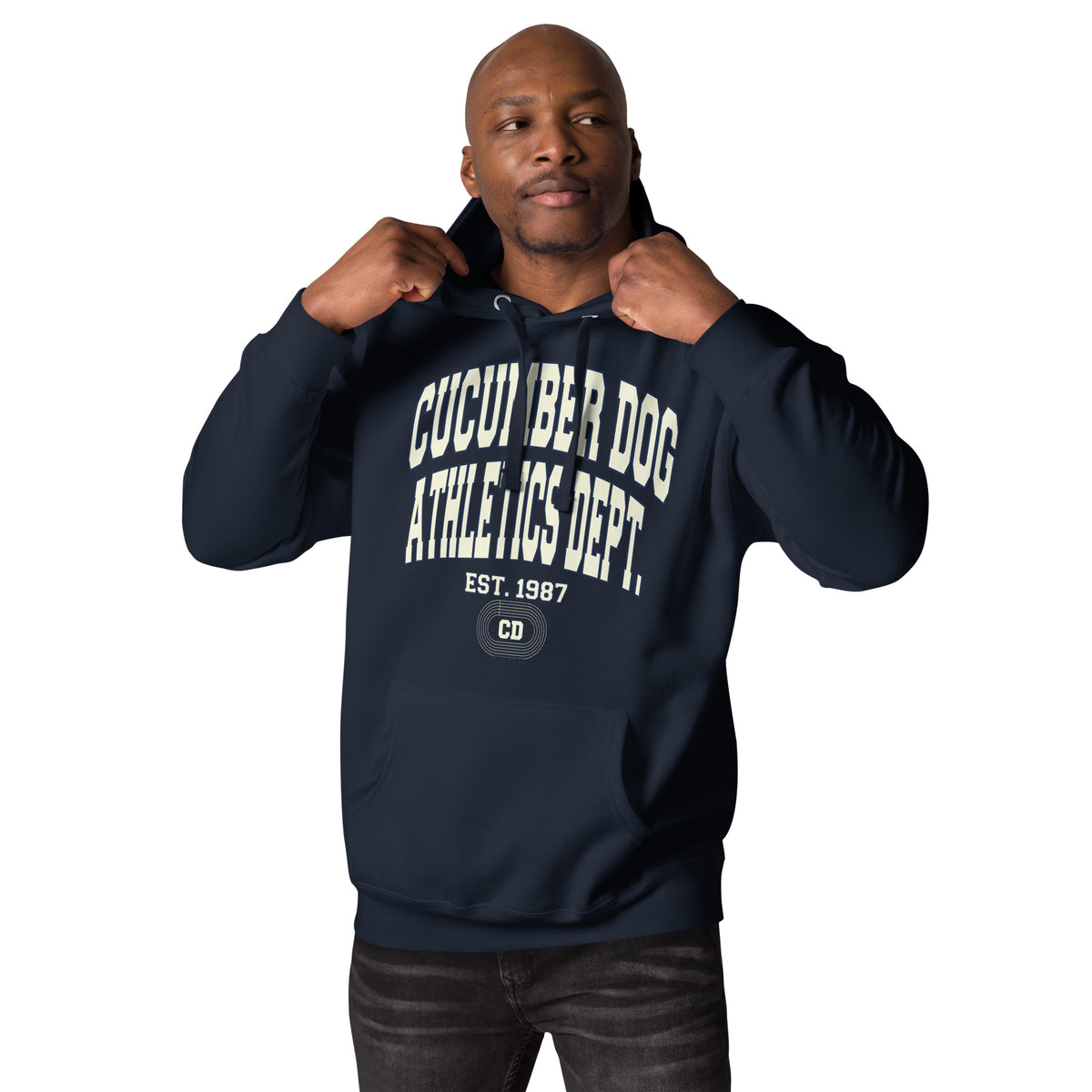 Navy hoodie featuring a monochromatic collegiate graphic with arched Cucumber Dog and Athletics Dept text in solid cream, Est. 1987, and a track motif framing the CD monogram.