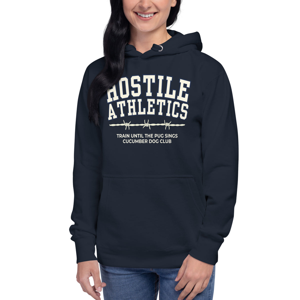 Premium navy blue hoodie featuring a vintage athletic graphic with arched Hostile Athletics text in white, a barbed wire motif, and text reading Train Until The Pug Sings and Cucumber Dog Club.