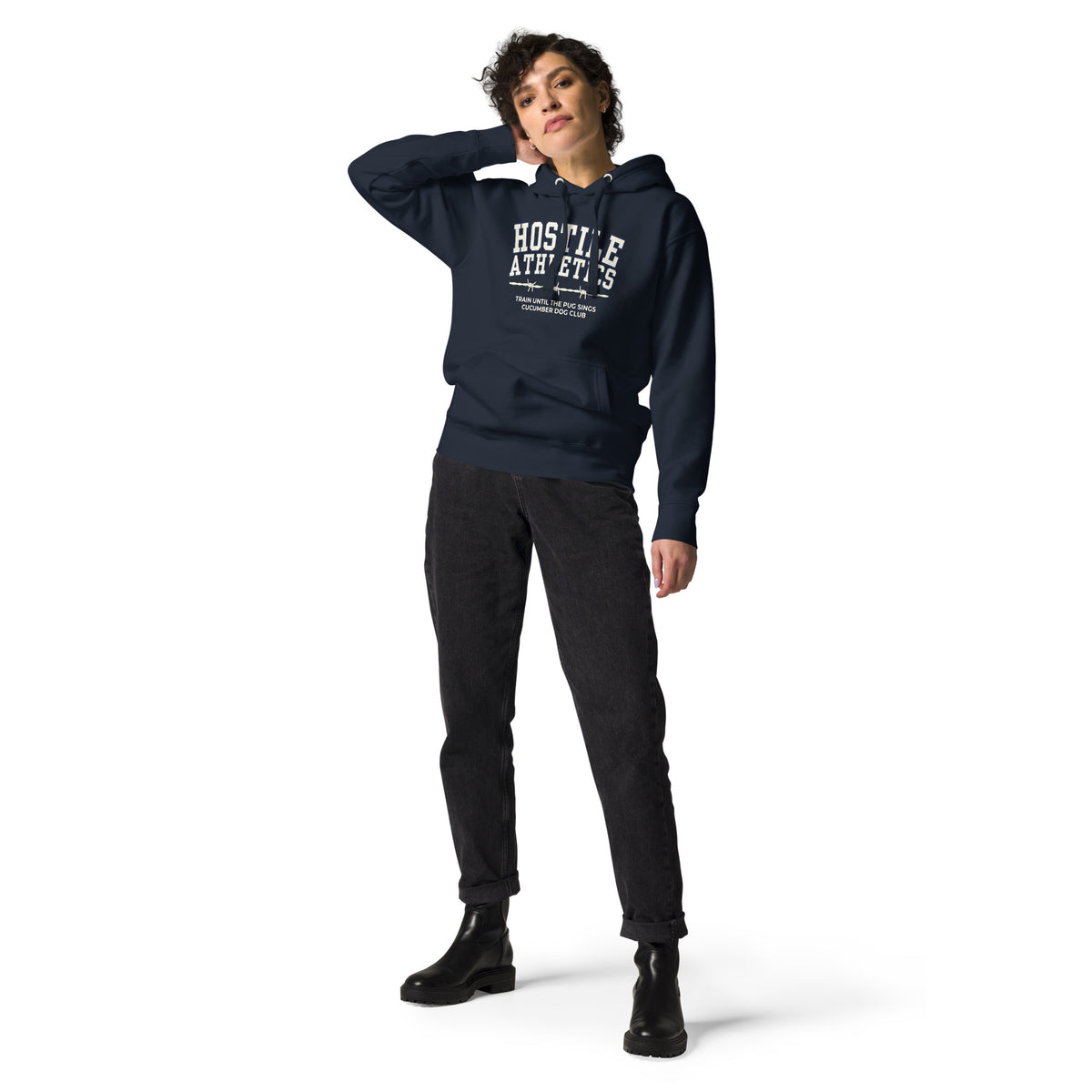 Premium navy blue hoodie featuring a vintage athletic graphic with arched Hostile Athletics text in white, a barbed wire motif, and text reading Train Until The Pug Sings and Cucumber Dog Club.
