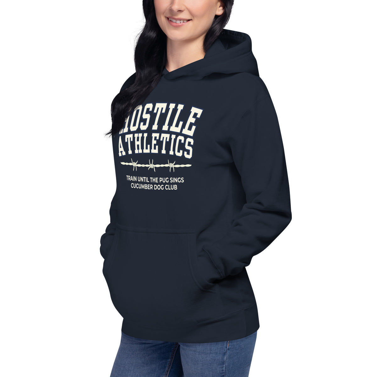 Premium navy blue hoodie featuring a vintage athletic graphic with arched Hostile Athletics text in white, a barbed wire motif, and text reading Train Until The Pug Sings and Cucumber Dog Club.