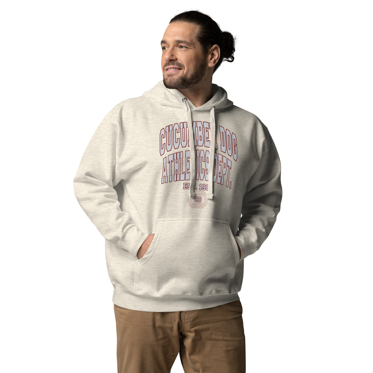 Premium oatmeal heather hoodie featuring a vintage athletic graphic with arched Cucumber Dog and Athletics Dept text in grey block typography with a maroon outline, above Est. 1987 and a track motif framing the CD monogram.