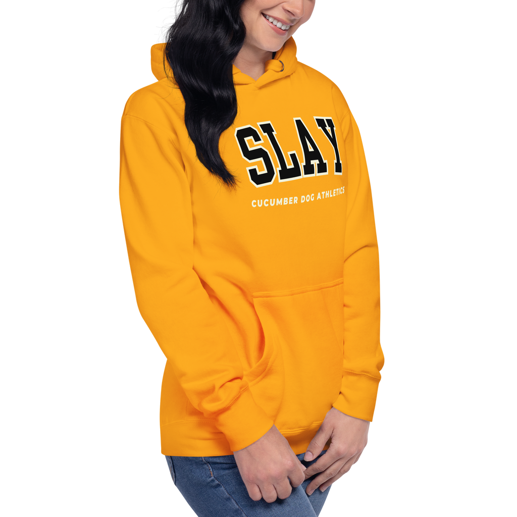 A woman wearing a bright Gold pullover hoodie with 'SLAY' and 'CUCUMBER DOG ATHLETIC' printed on the front, shown against a plain white background.