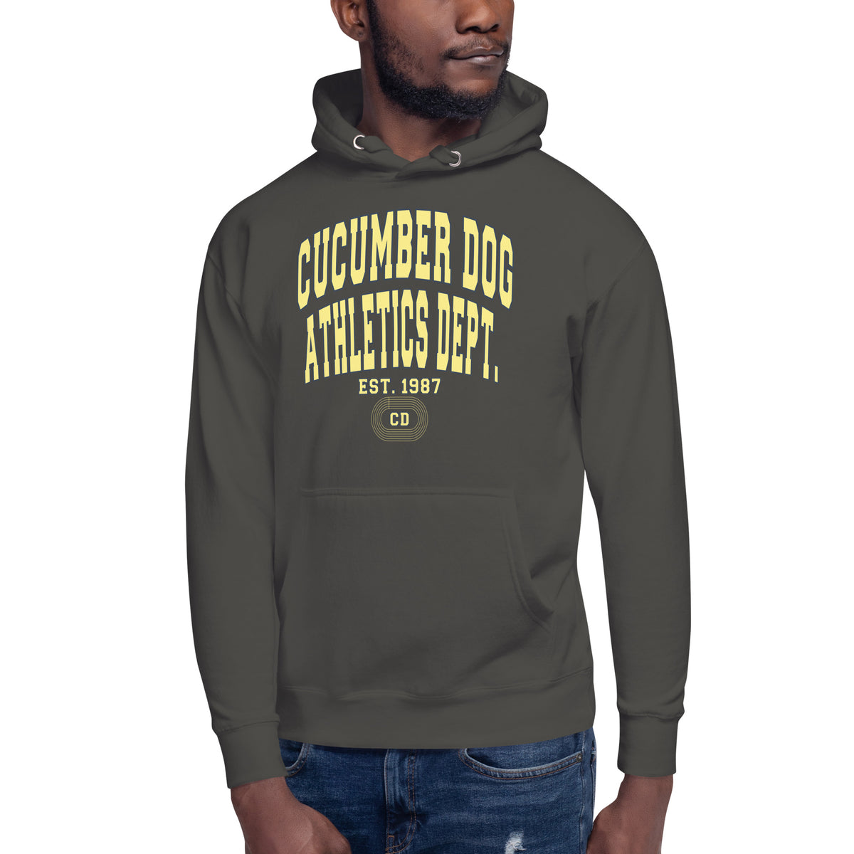 Premium vintage black hoodie featuring a vintage athletic graphic with arched Cucumber Dog and Athletics Dept text in solid butter cream block typography, above Est. 1987 and a track motif framing the CD monogram.