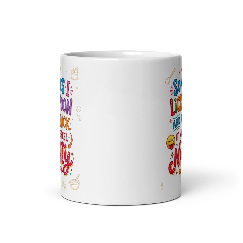 A white ceramic mug featuring playful and colourful typography in blue, pink, orange, and purple. The text reads SOMETIMES I LICK THE SPOON AND PUT IT BACK IT MAKES ME FEEL NAUGHTY. The design is decorated with small hand drawn icons of spoons, stars, a bag of flour, and a winking emoji with its tongue sticking out.