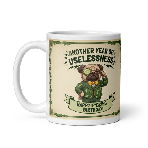 A two sided ceramic mug design on a cream background with a green cucumber border. The front features Sir Cucumber Dog in a green suit adjusting a monocle with the text ANOTHER YEAR OF USELESSNESS and HAPPY F*CKING BIRTHDAY. The back features text stating A MUG IS A BETTER CARD and a fill in the blank template for insults. 11 oz