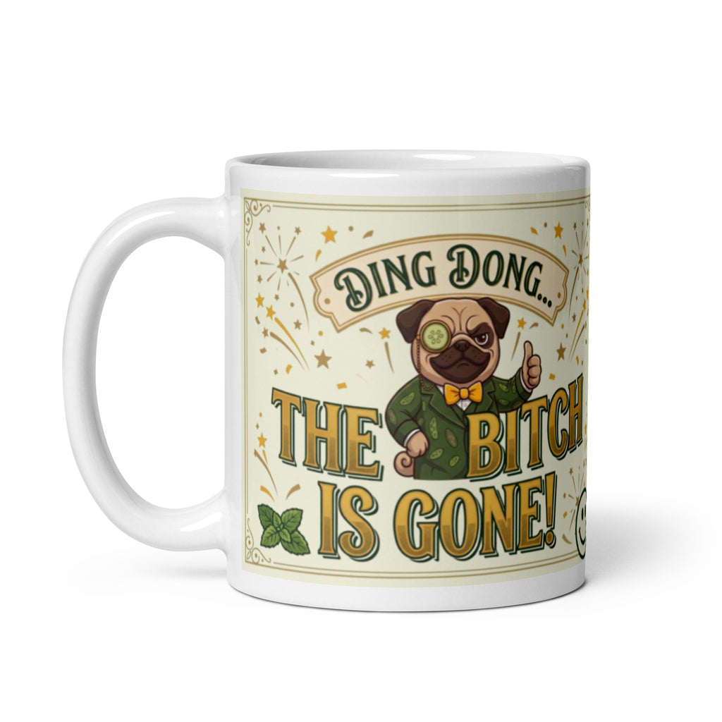 A funny, vintage-inspired graphic on a light cream background with a gold border. Features a pug named Sir Cucumber Dog wearing a monocle and a green suit, giving a thumbs up next to the bold text DING DONG... THE BITCH IS GONE! surrounded by illustrated fireworks. 11 oz