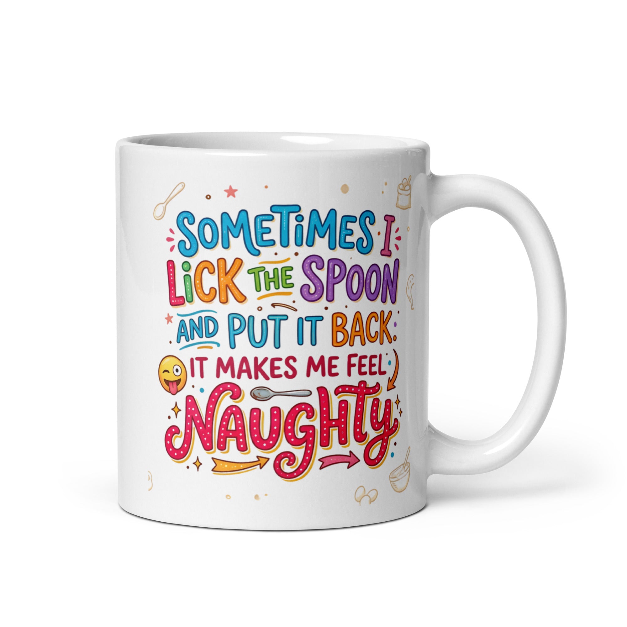 A white ceramic mug featuring playful and colourful typography in blue, pink, orange, and purple. The text reads SOMETIMES I LICK THE SPOON AND PUT IT BACK IT MAKES ME FEEL NAUGHTY. The design is decorated with small hand drawn icons of spoons, stars, a bag of flour, and a winking emoji with its tongue sticking out.