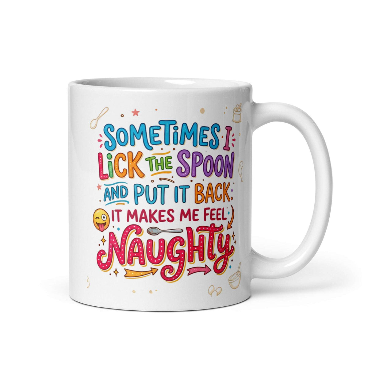 A white ceramic mug featuring playful and colourful typography in blue, pink, orange, and purple. The text reads SOMETIMES I LICK THE SPOON AND PUT IT BACK IT MAKES ME FEEL NAUGHTY. The design is decorated with small hand drawn icons of spoons, stars, a bag of flour, and a winking emoji with its tongue sticking out.