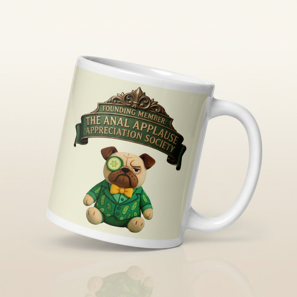 A premium 11oz mug design featuring an ornate green banner with the text Founding Member: The Anal Applause Appreciation Society above a plush pug in a cucumber suit and monocle on a Cucumber cream background. Cucumber Dog.