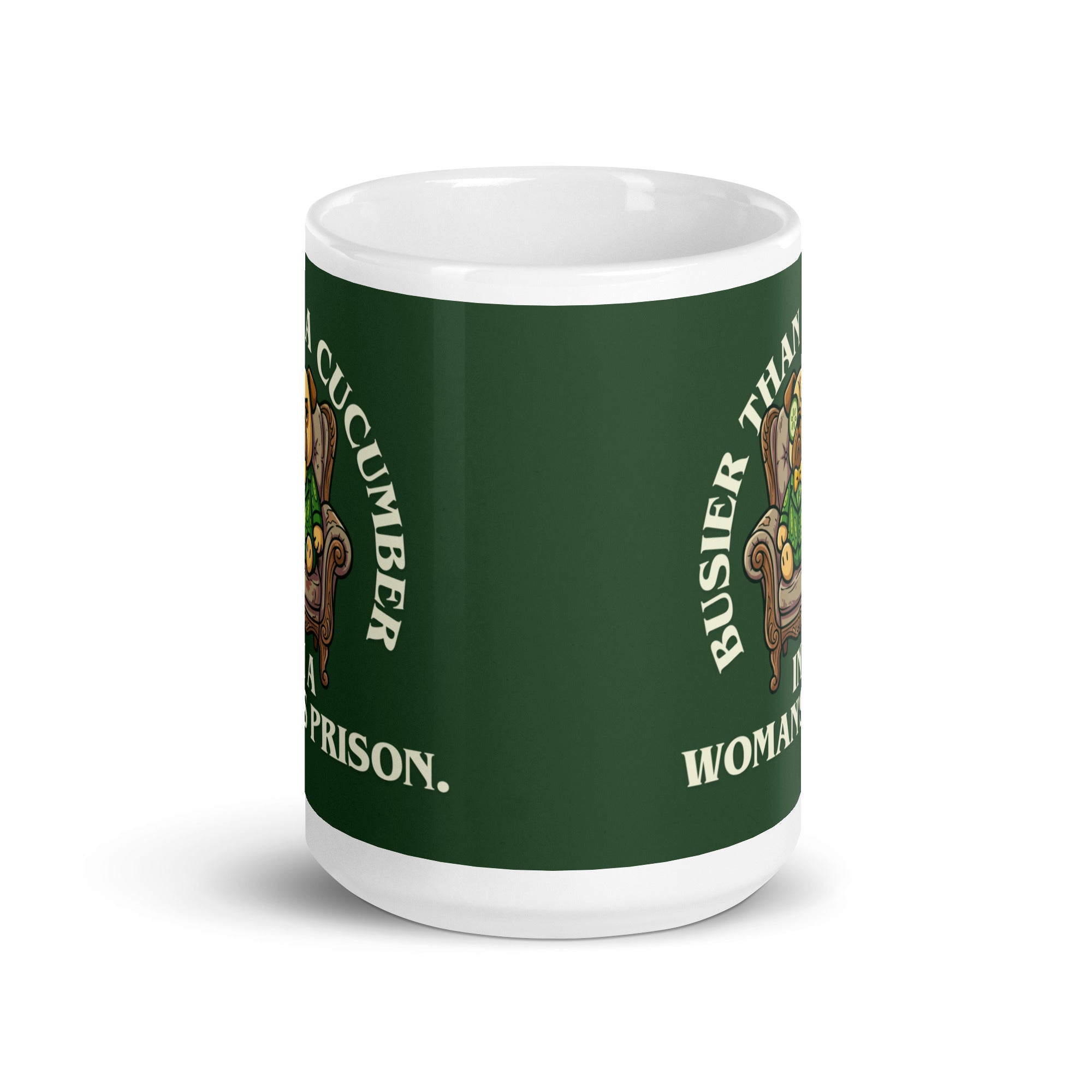 A tilted white ceramic mug with a large dark green label. In the centre of the label, a pug named Sir Cucumber Dog sits in an armchair wearing a cucumber suit and monocle. The white text reads BUSIER THAN A CUCUMBER IN A WOMAN S PRISON. 15oz

