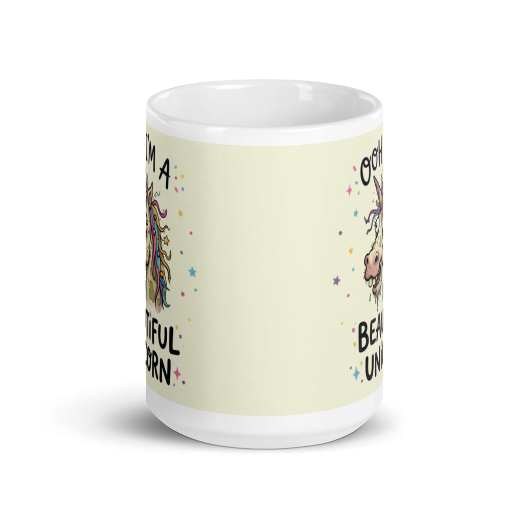 A funny, chaotic illustration on a white ceramic mug of a deranged, ugly unicorn with bloodshot eyes, crooked teeth, and messy pastel hair. The text reads OOH I'M A BEAUTIFUL UNICORN surrounded by small stars. 15 oz